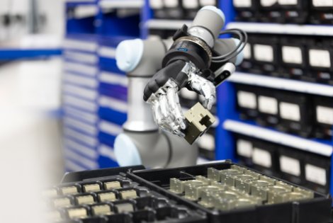 SCHUNK SVH five-finger dexterous robotic hand grasping a component